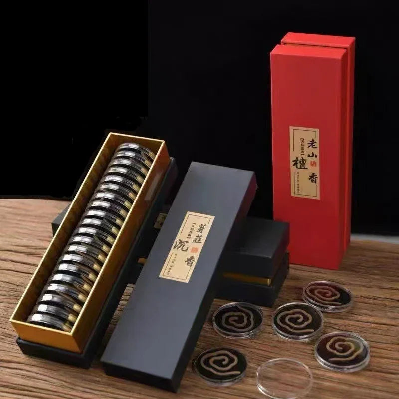 Black and red incense packaging boxes with spiral incense coils on wooden surface