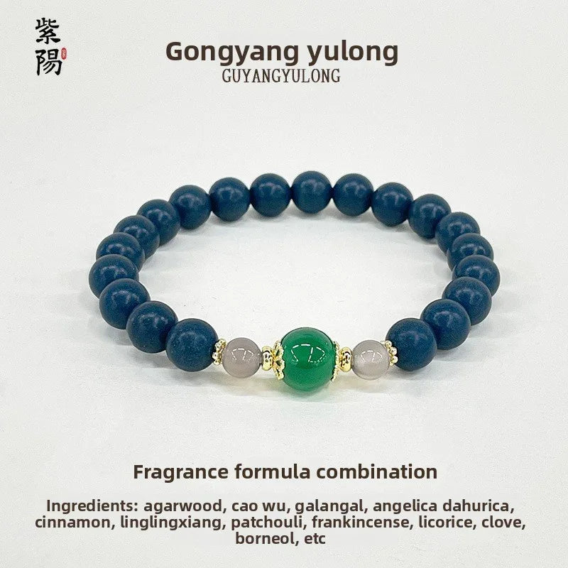 Gongyang Yulong bracelet with blue beads and central green bead accented by smaller grey beads and gold details