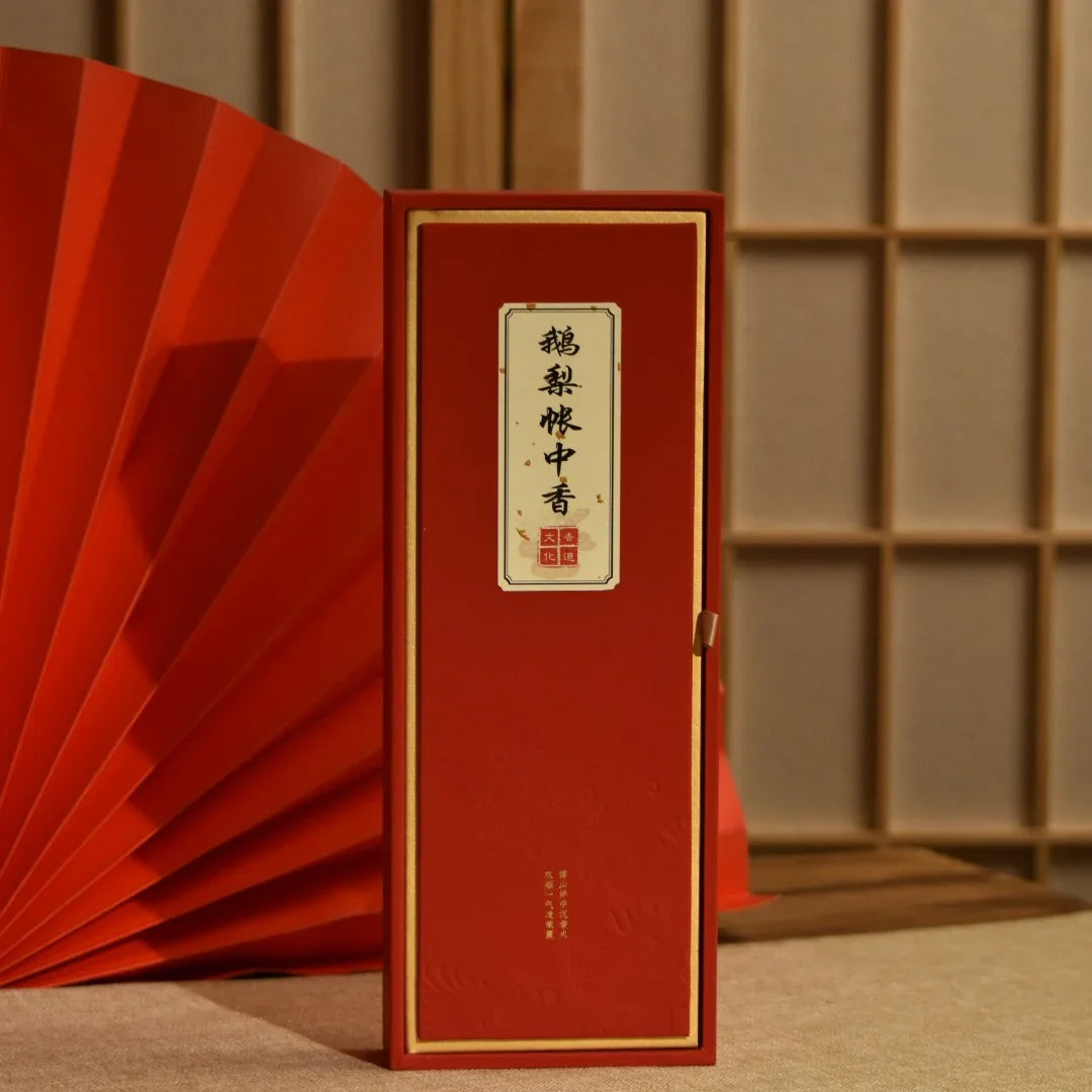 Red rectangular Chinese tea packaging box with gold-bordered label and Chinese characters, traditional decor