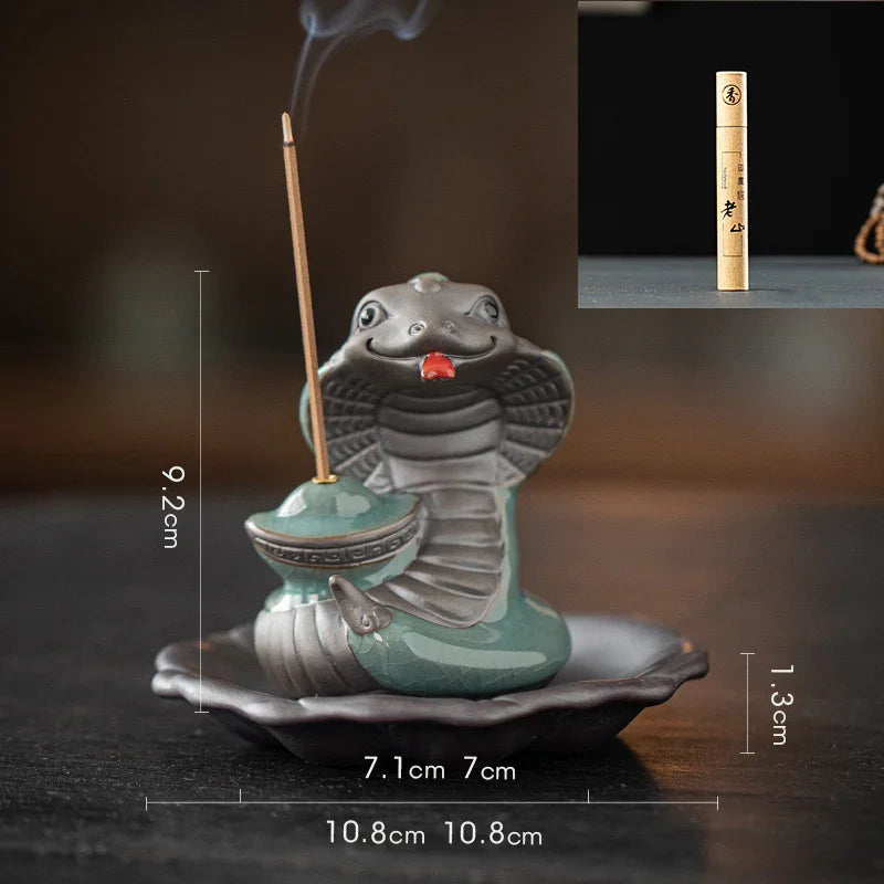 Ceramic cobra incense holder with lit incense stick and smoke, on a decorative tray, size dimensions shown