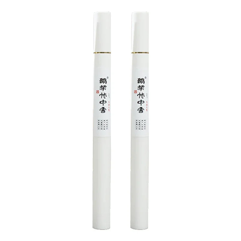 Two white cylindrical incense sticks with black Chinese characters on white labels against white background