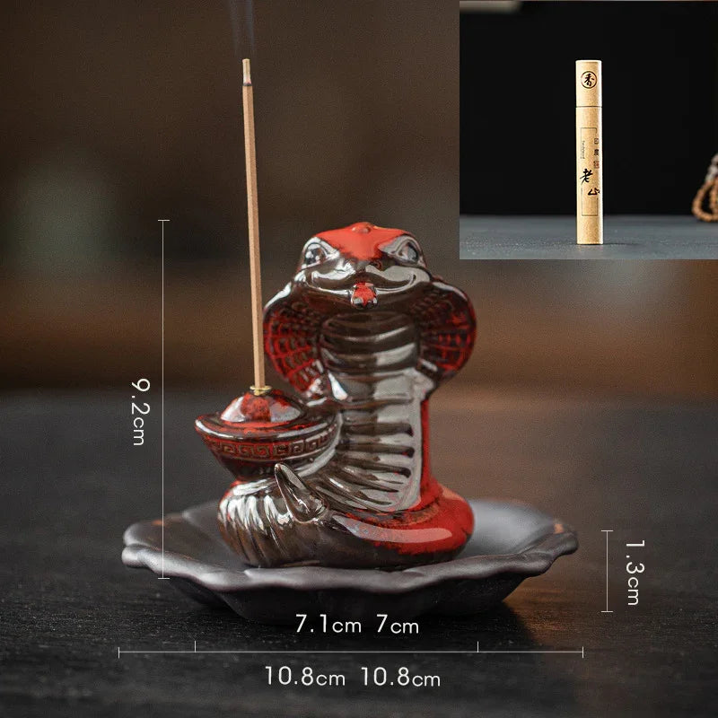 Ceramic cobra incense holder with incense stick on a leaf-shaped base with size measurements