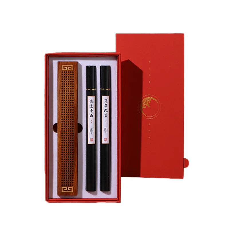 Red gift box with wooden incense holder and two black incense sticks with Chinese labels