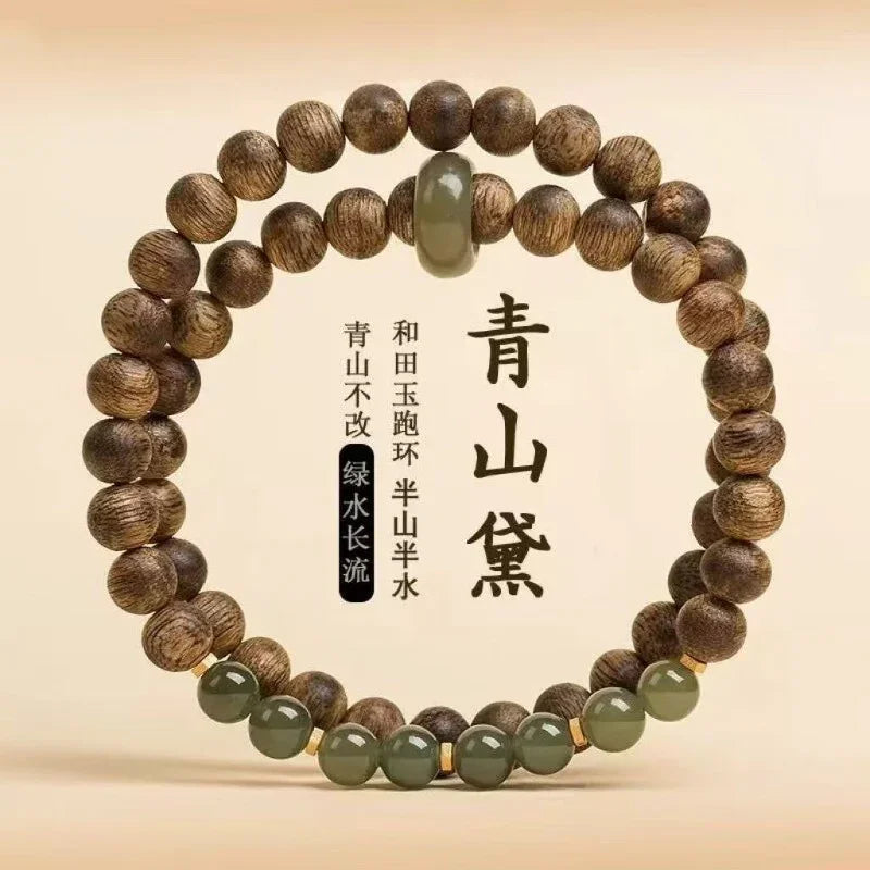 Wooden bead bracelet with green jade beads and golden spacers on beige background