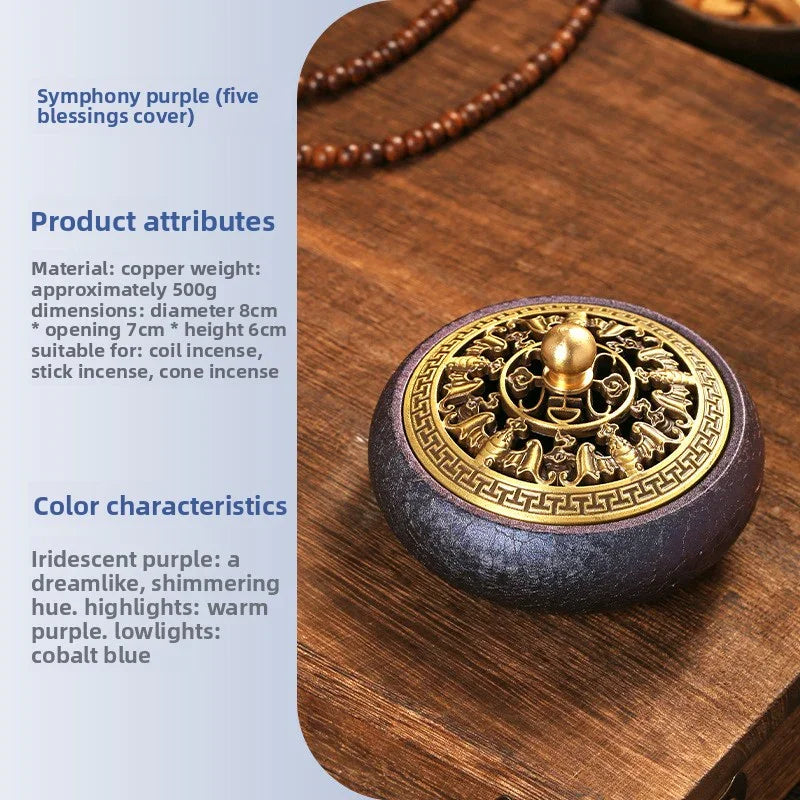 Copper incense burner with iridescent purple base and gold five blessings cover on wooden surface