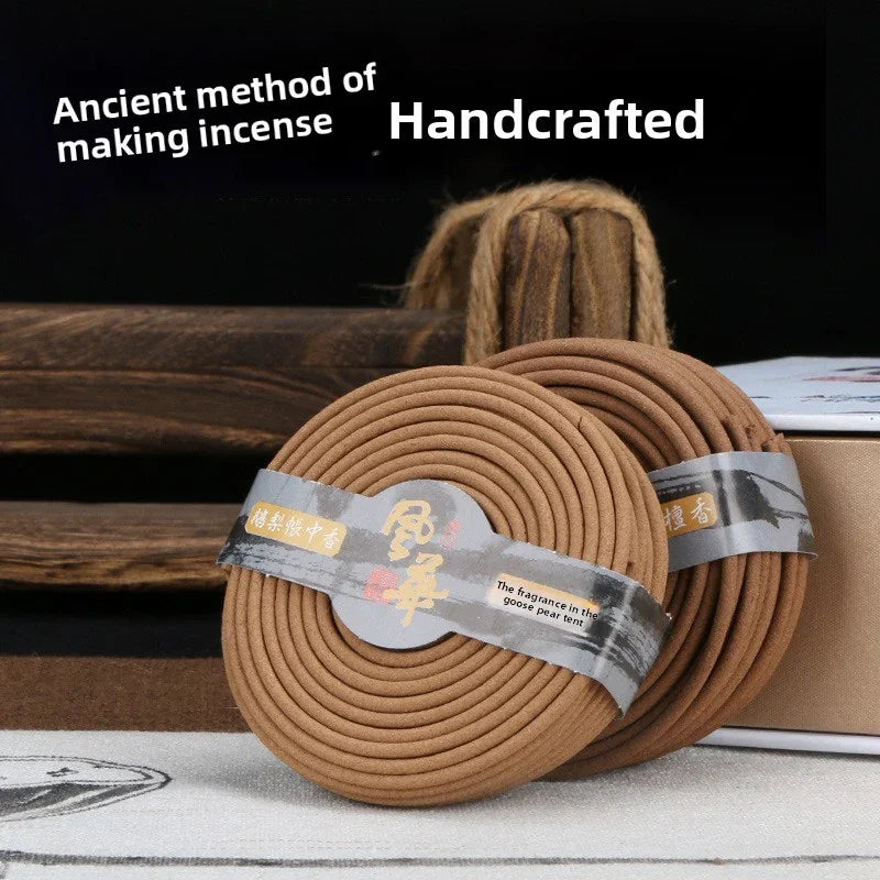 Handcrafted coil incense rolls with ancient method packaging on wooden surface