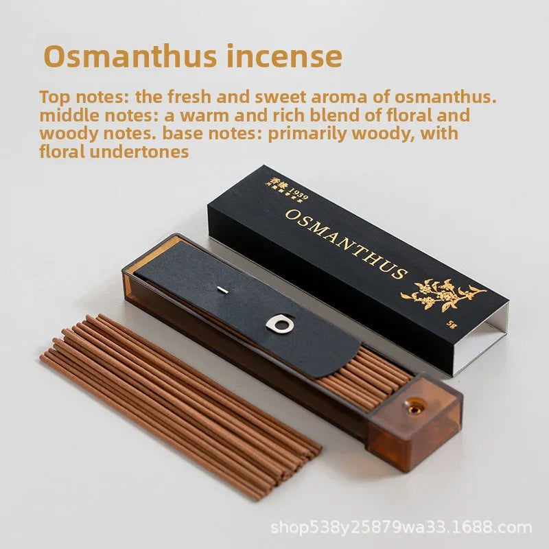 Osmanthus incense sticks with black and gold packaging and wooden incense holder on white surface