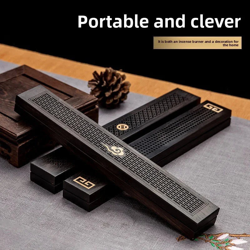 Elegant portable wooden incense burner with intricate patterns and decorative box on cloth surface
