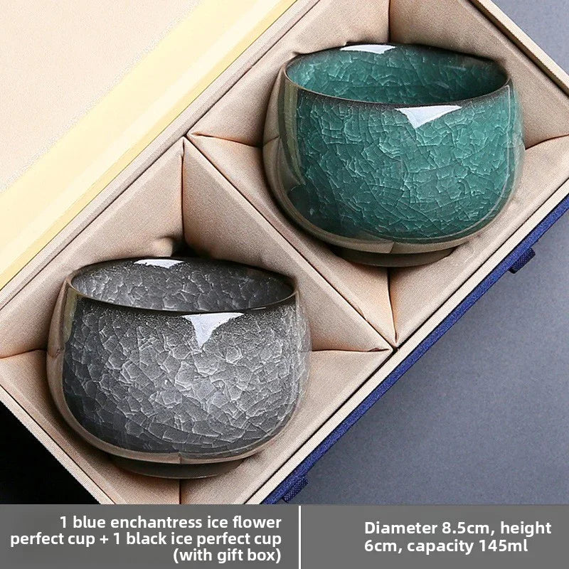 Set of two textured ceramic tea cups in black and green in a beige gift box