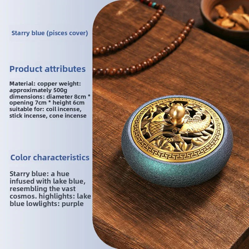 Starry blue copper incense burner with golden koi fish lid on wooden tray, surrounded by wooden beads and dried herbs