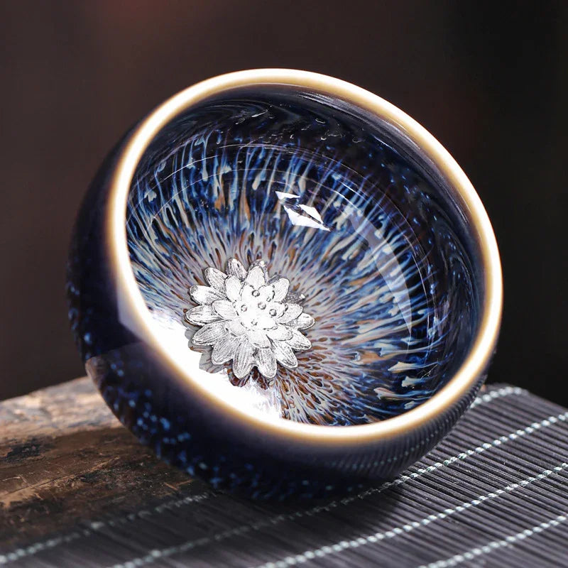 Close-up of a blue ceramic bowl with intricate white floral design inside, placed on a wooden surface