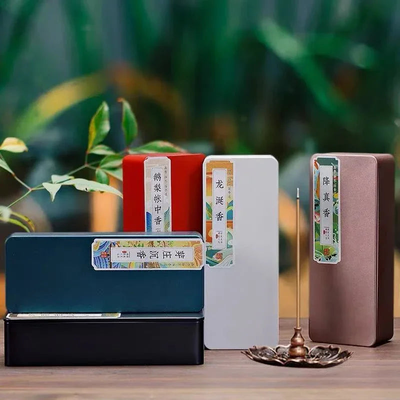 Colorful rectangular incense gift boxes with Chinese labels and a lit incense stick in a lotus holder on wooden table