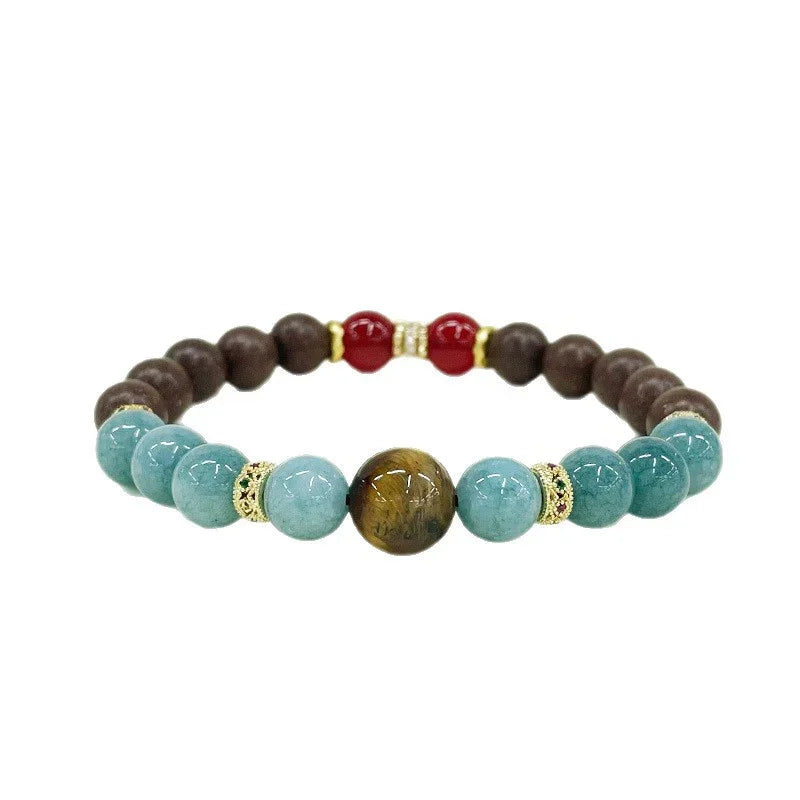 beaded bracelet with turquoise, brown, red, and tiger eye stones accented by gold spacers