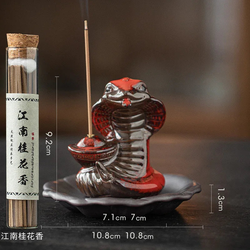 Red and black ceramic cobra incense holder with lit stick and tube of Jiangnan osmanthus incense sticks