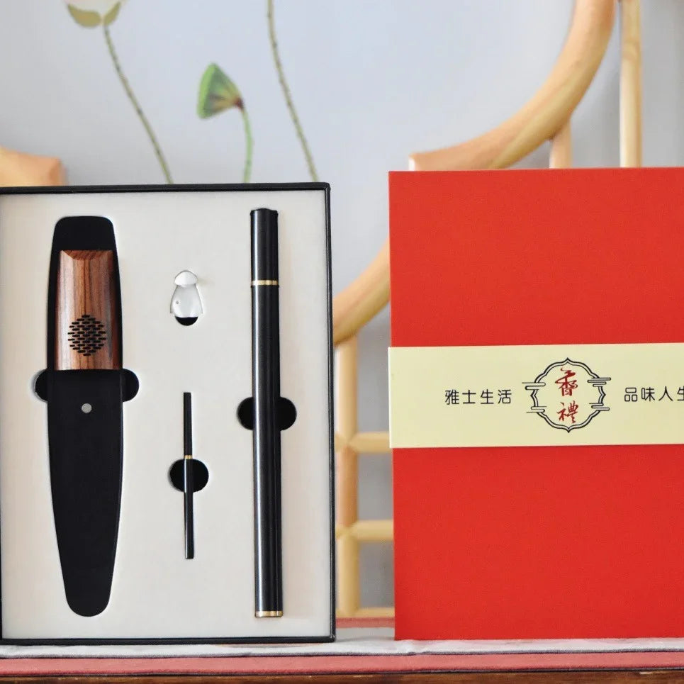 Gift set with wooden and black electronic device, pen, and accessories in a white box next to red packaging