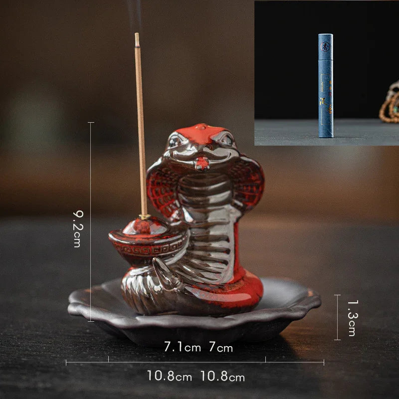 Ceramic cobra incense holder with extended incense stick on dark surface with size measurements