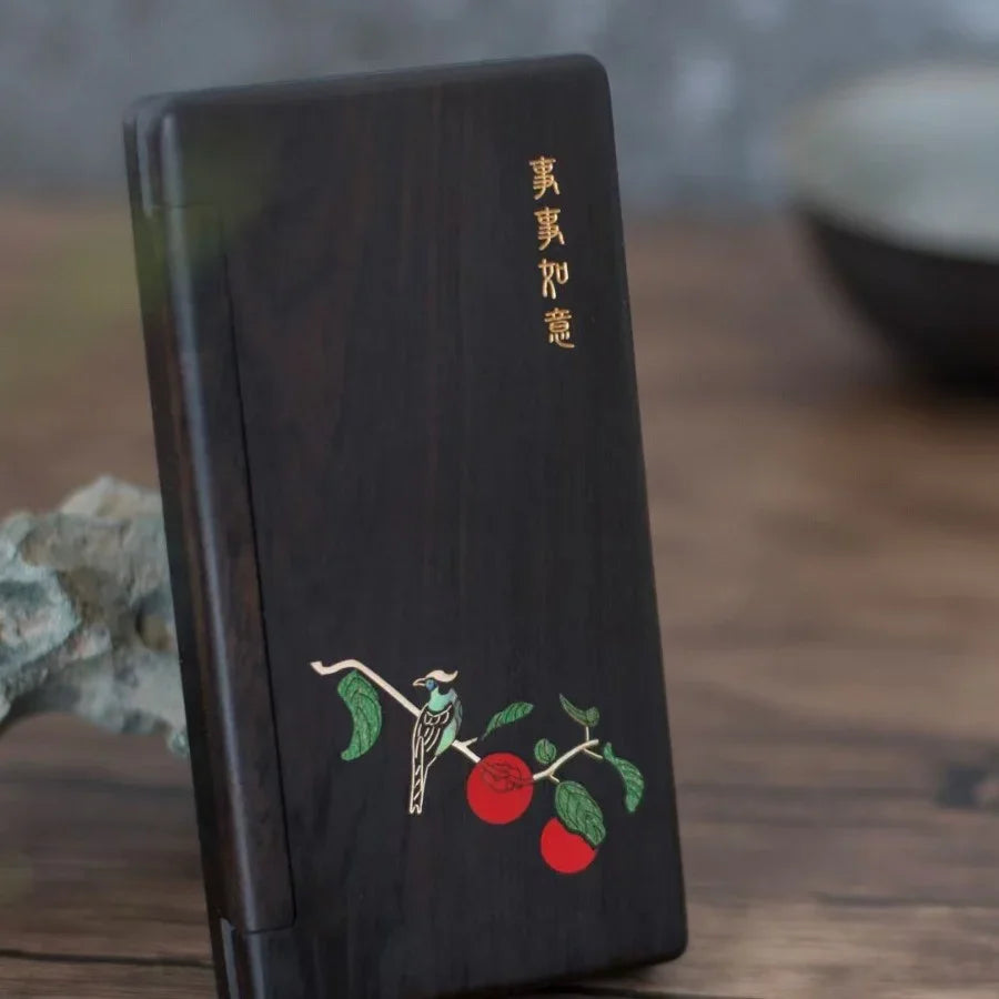 Dark wooden phone case with colorful bird and fruit branch design and gold Chinese characters