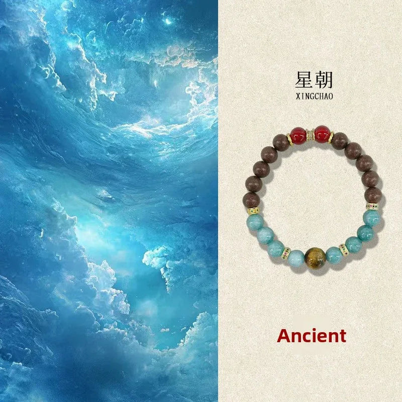 Xingchao Ancient beaded bracelet with brown, red, blue, and tiger eye beads on a beige background