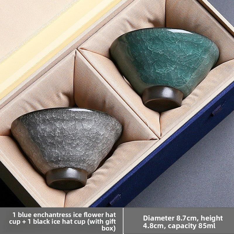 Set of one blue and one black ceramic ice flower hat cups with crackled glaze in a cushioned gift box