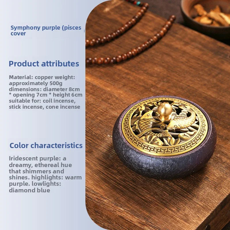 Copper incense holder with intricate gold fish design on iridescent purple base on wooden surface
